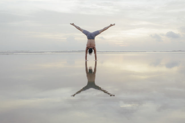 Beautiful Yoga portrait of yoga teacher Daniel Scott near the sea